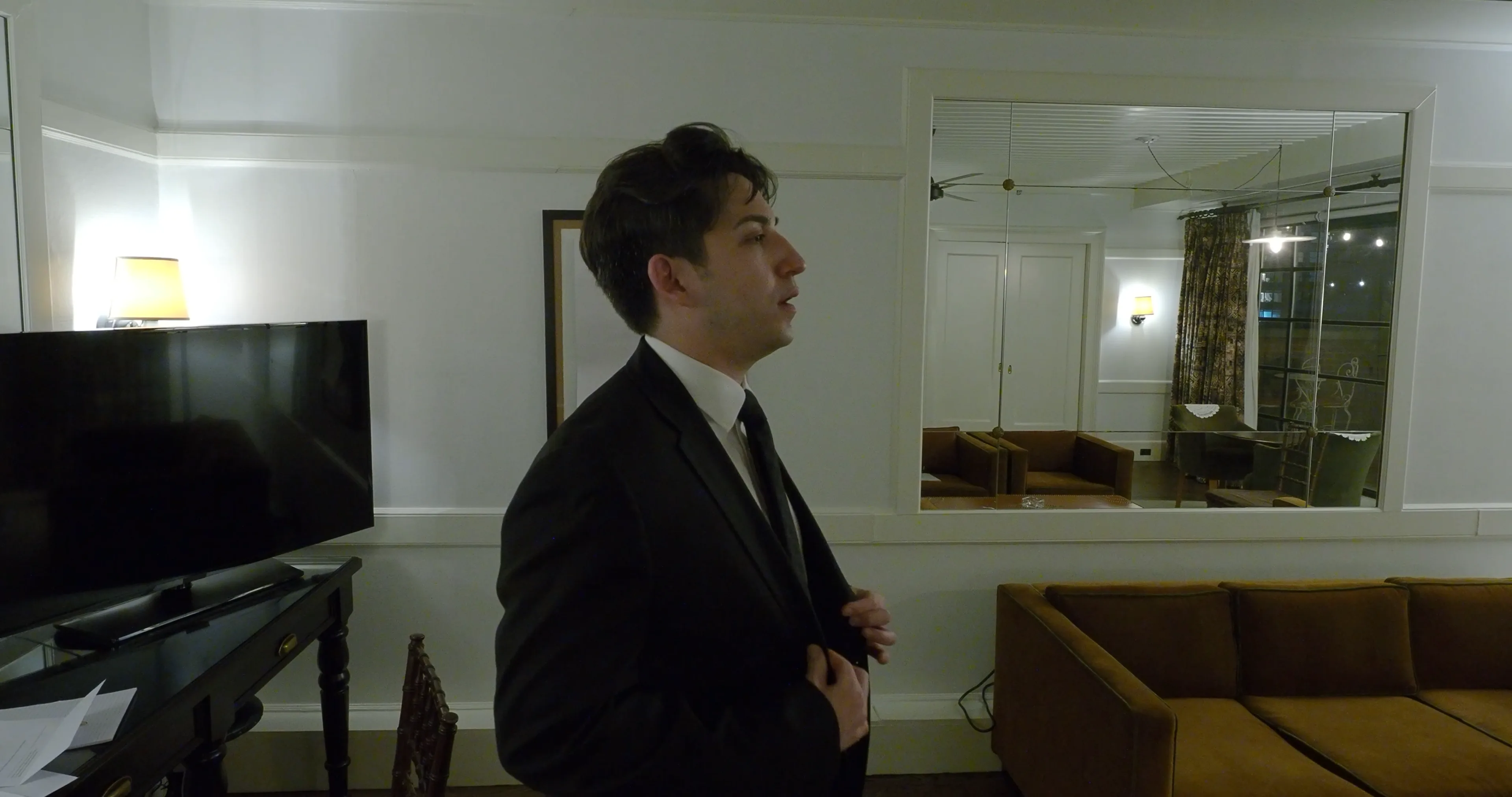 Ian Bloom as The Gangster in Big Time in a close profile portrait under hotel light