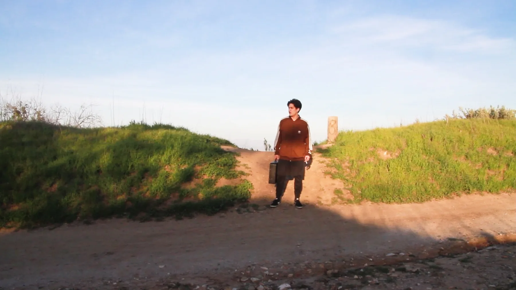 Ian Bloom in Driver 2016 standing on an empty concrete road in the zone in Los Angeles