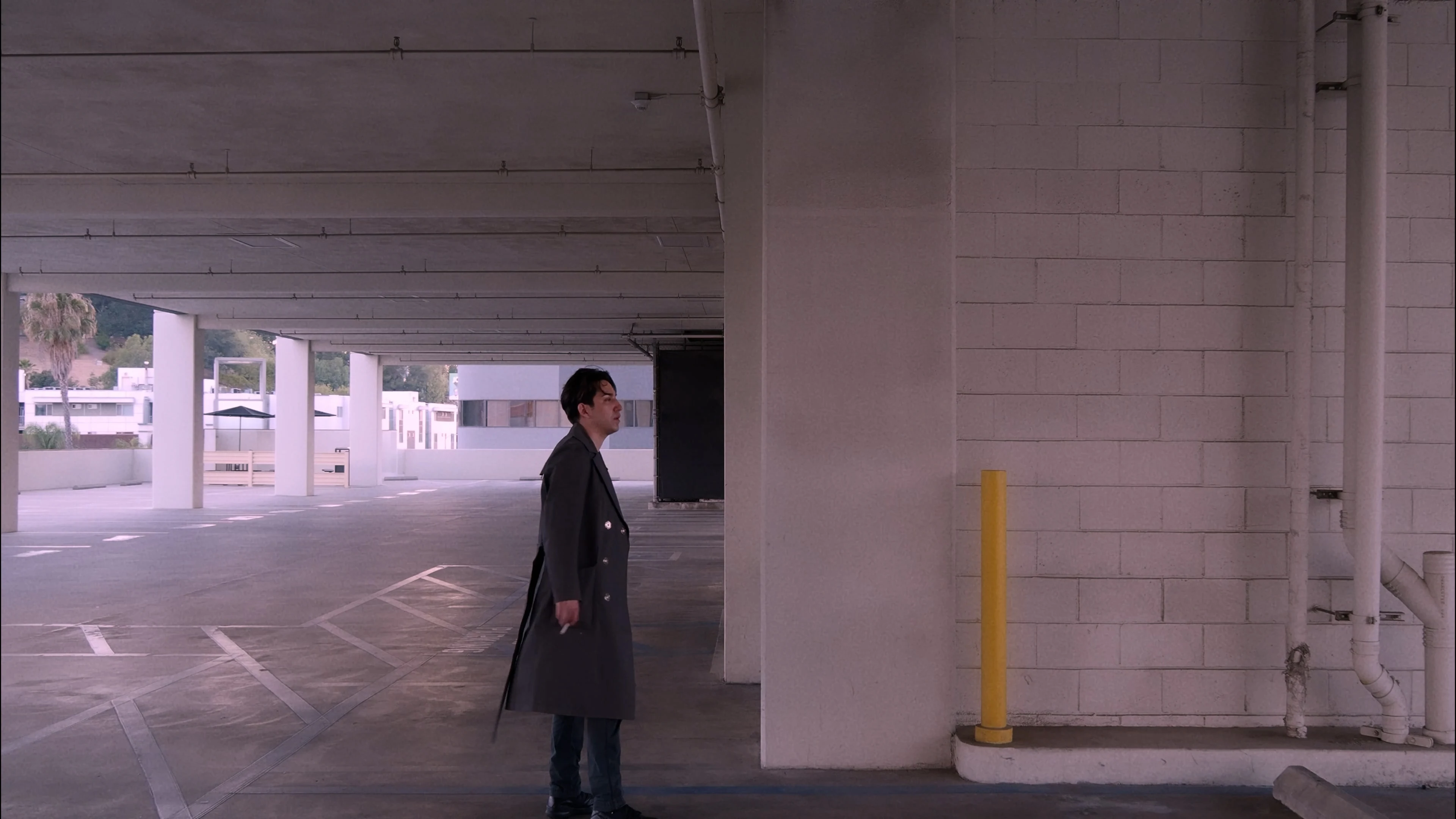 Ian Bloom in King standing wide in the desert with a bag on the ground