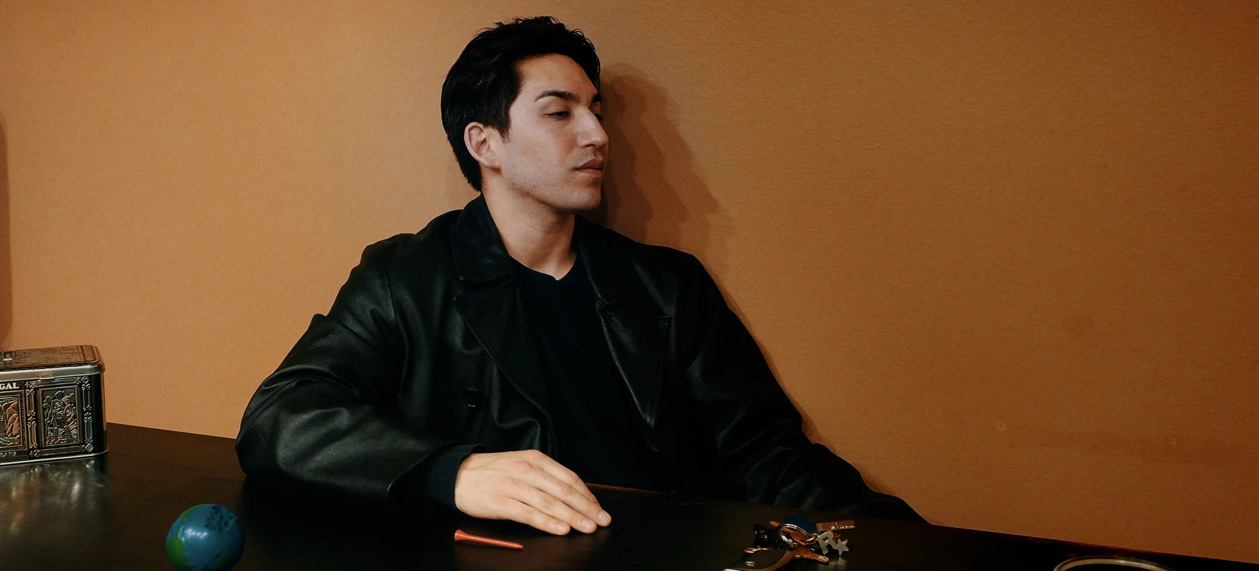 Ian Bloom as The Star in Star Vehicle in a formal interior with a composed expression