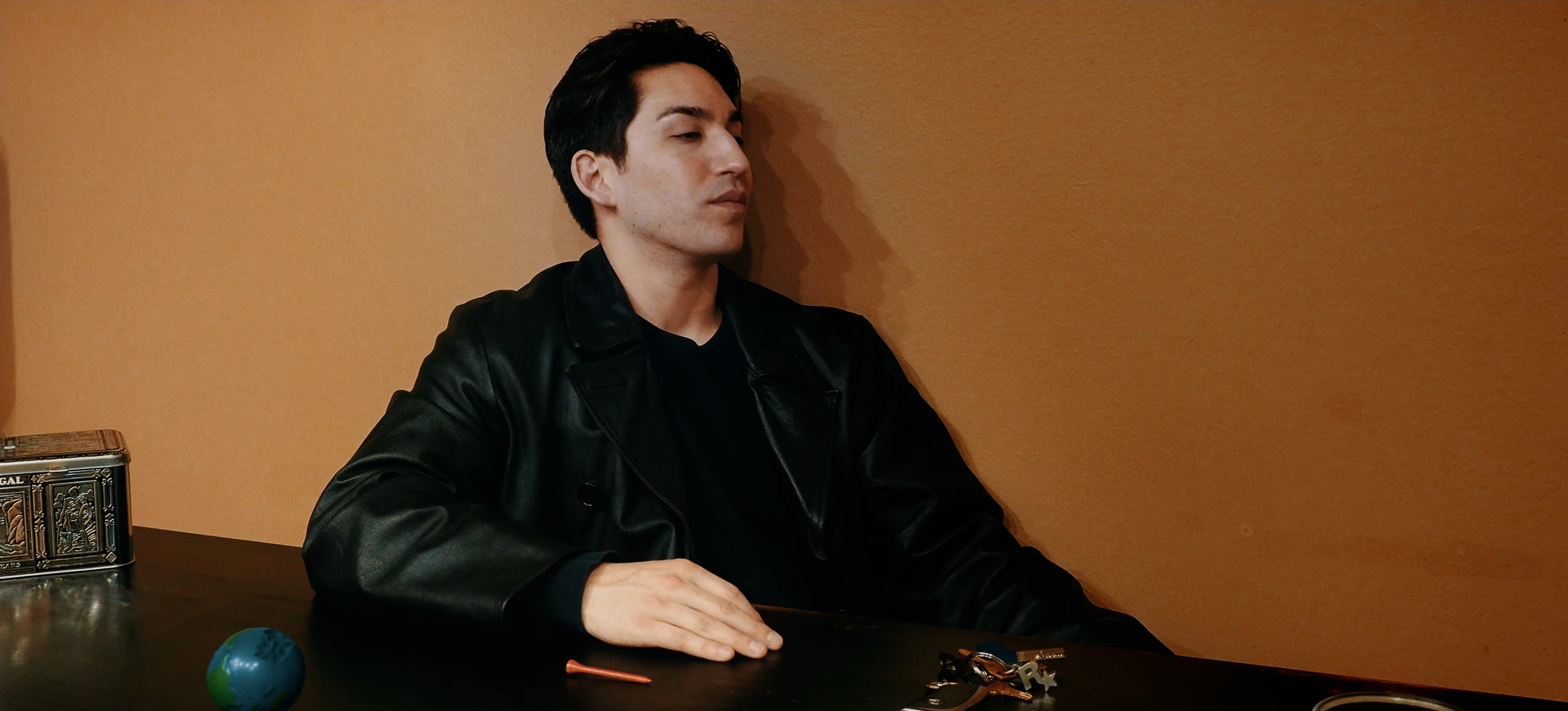 Ian Bloom as The Suit in Star Vehicle in a dark interior at the end of the film